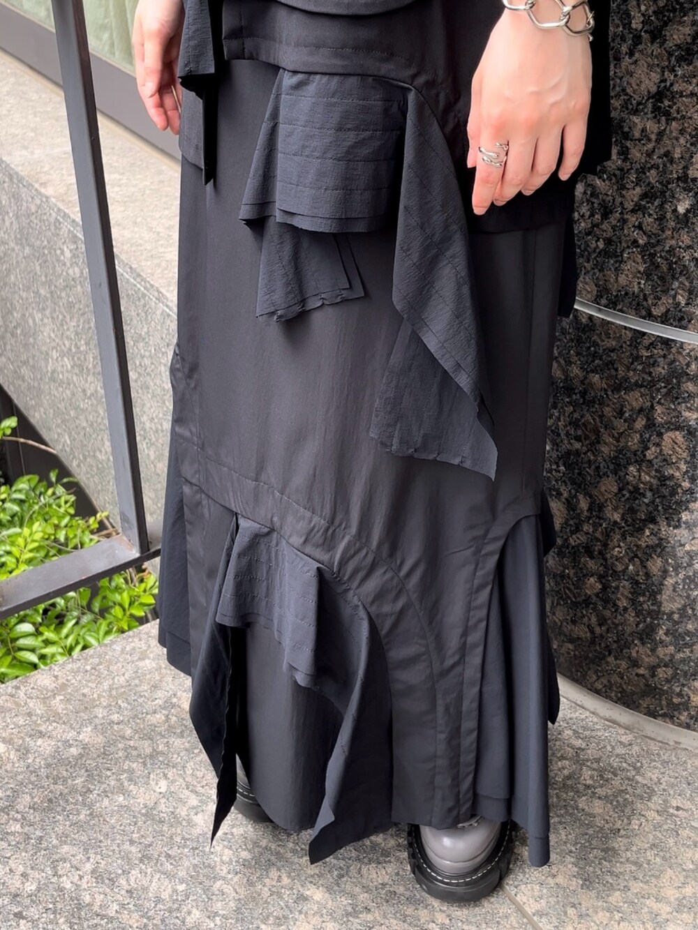 ブラック系のTシャツ/カットソー、ブラック系のスカート、グレー系のローファーを着用したレディースの秋コーディネートの8枚目の写真