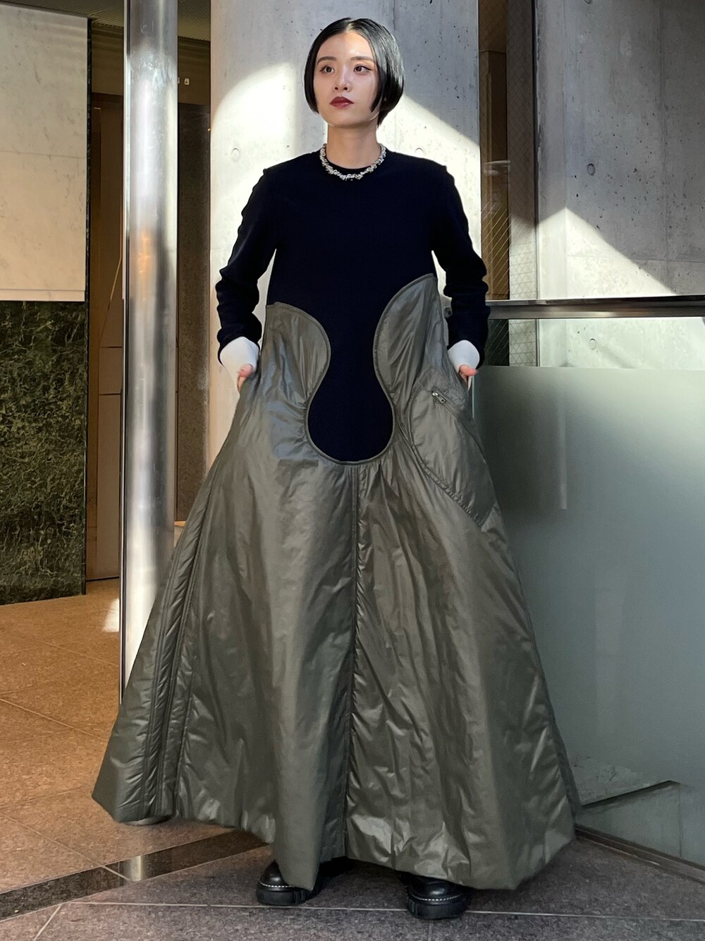 ベージュ系のワンピース、ブラック系のブーツ、シルバー系のネックレスを着用したレディースの秋コーディネートの3枚目の写真