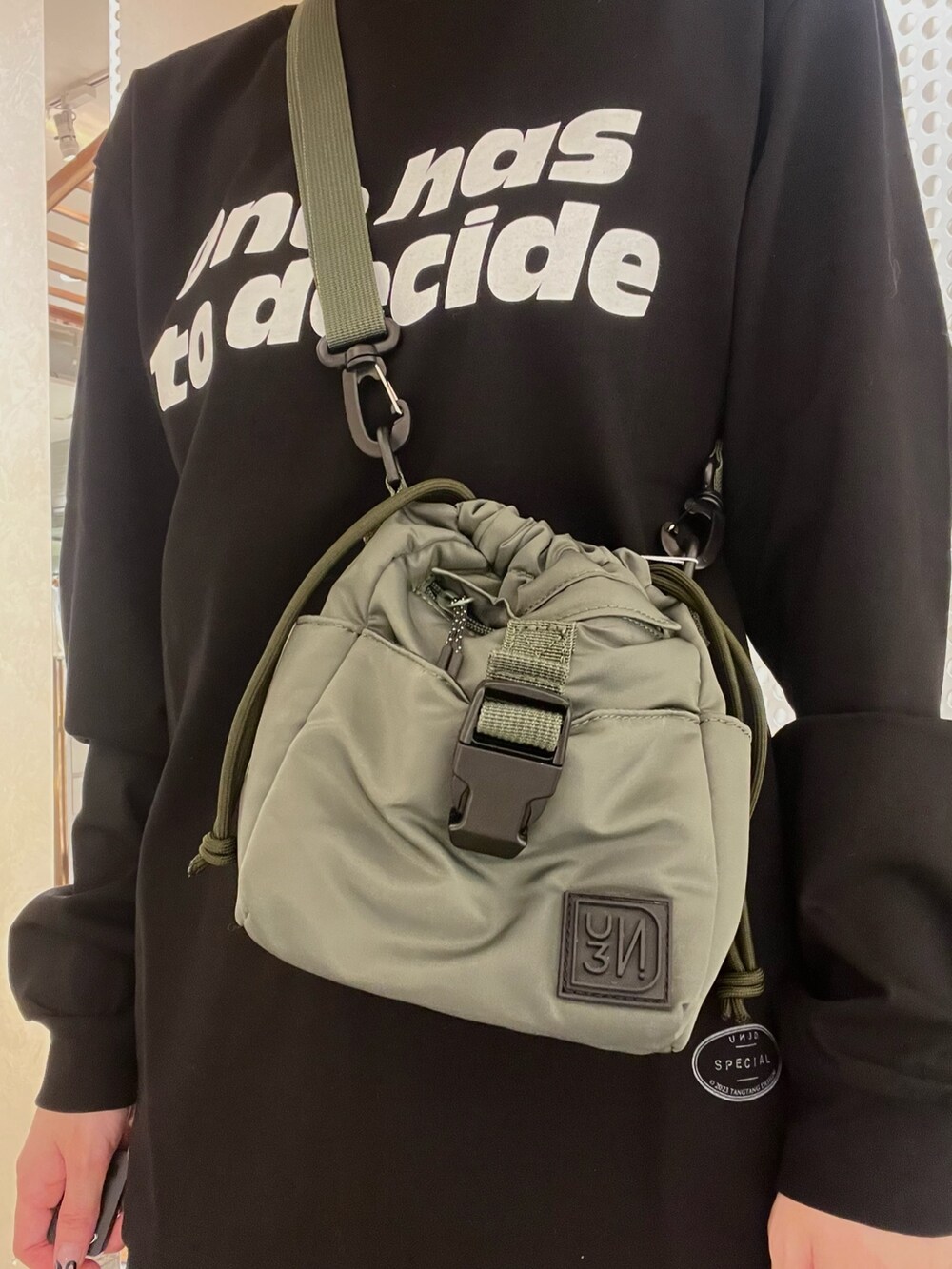 ブラック系のTシャツ/カットソー、ベージュ系のショルダーバッグ、その他のその他パンツを着用したレディースの秋コーディネートの7枚目の写真