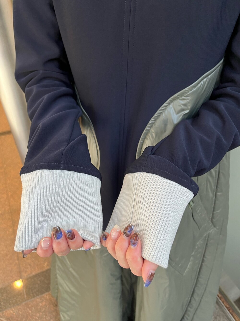 ベージュ系のワンピース、ブラック系のブーツ、シルバー系のネックレスを着用したレディースの秋コーディネートの7枚目の写真