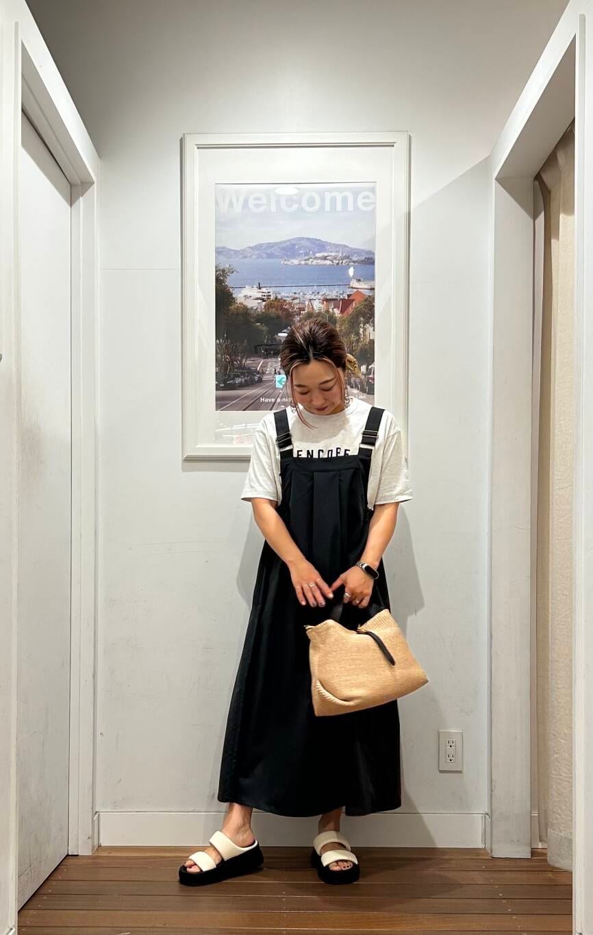 グレー系のワンピース、グレー系のTシャツ/カットソー、ホワイト系のサンダルを着用したレディースの春コーディネートの3枚目の写真