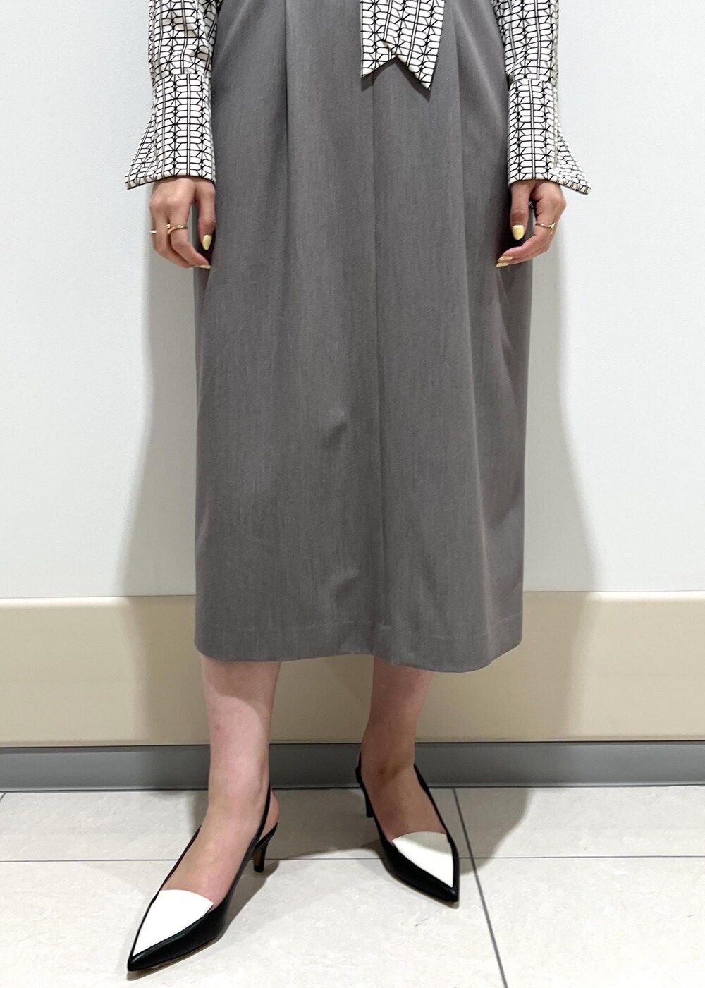 ホワイト系のシャツ/ブラウス、ブルー系のトートバッグ、ブラック系のパンプスを着用したレディースの春コーディネートの8枚目の写真