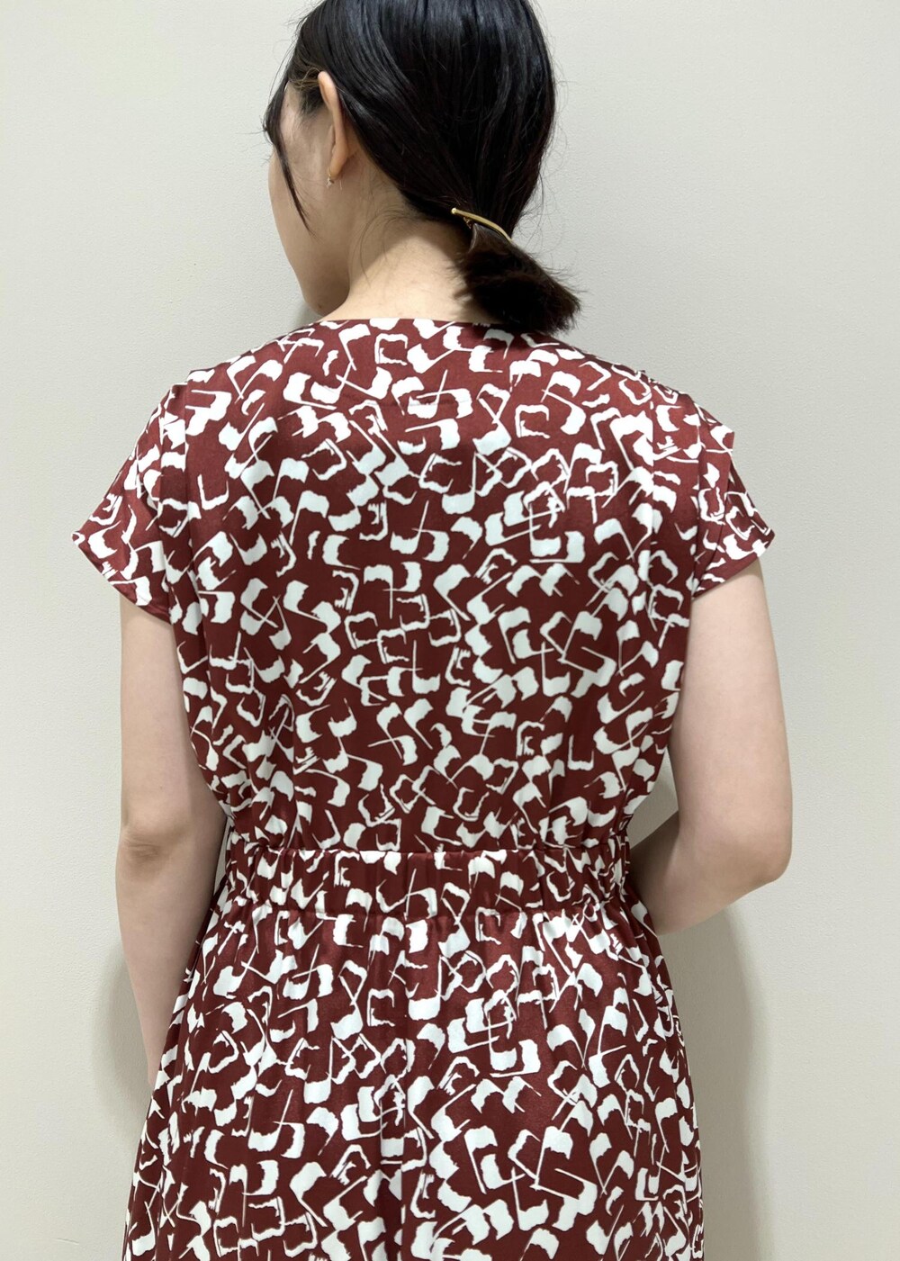 ブラック系のハンドバッグ、ベージュ系のサンダル、レッド系のワンピースを着用したレディースの夏コーディネートの5枚目の写真