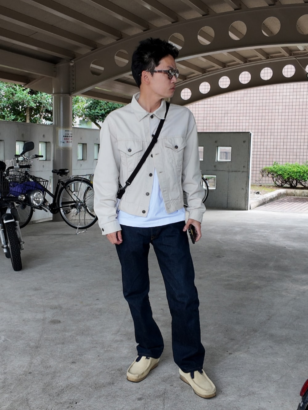 ブルー系のデニムパンツ、ベージュ系のブーツ、ホワイト系のTシャツ/カットソーを着用したメンズの秋コーディネートの5枚目の写真