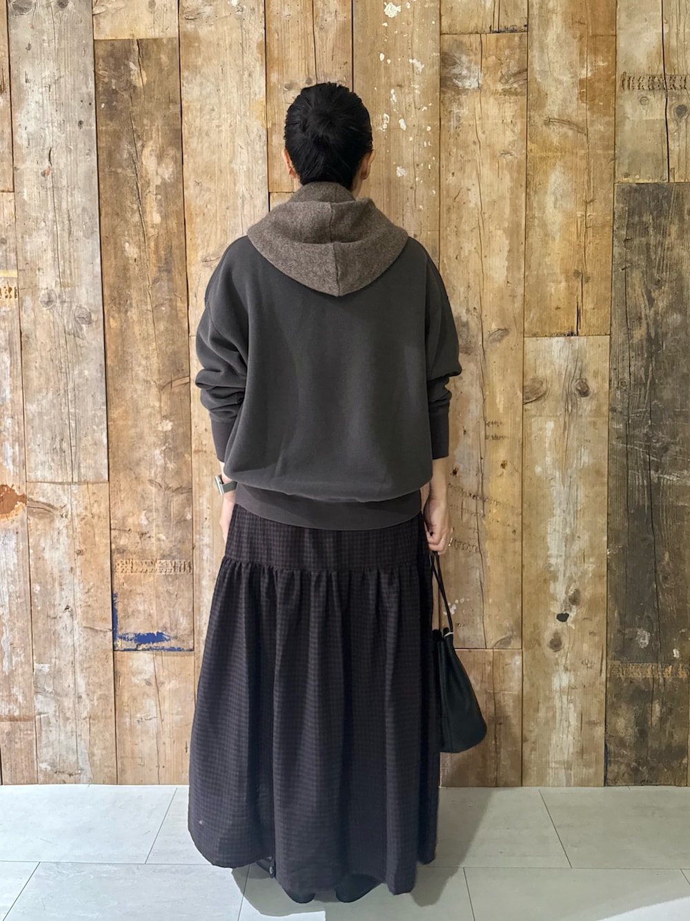 グレー系のスウェット、ブラウン系のスカート、ブラック系のバレエシューズを着用したレディースの冬コーディネートの3枚目の写真