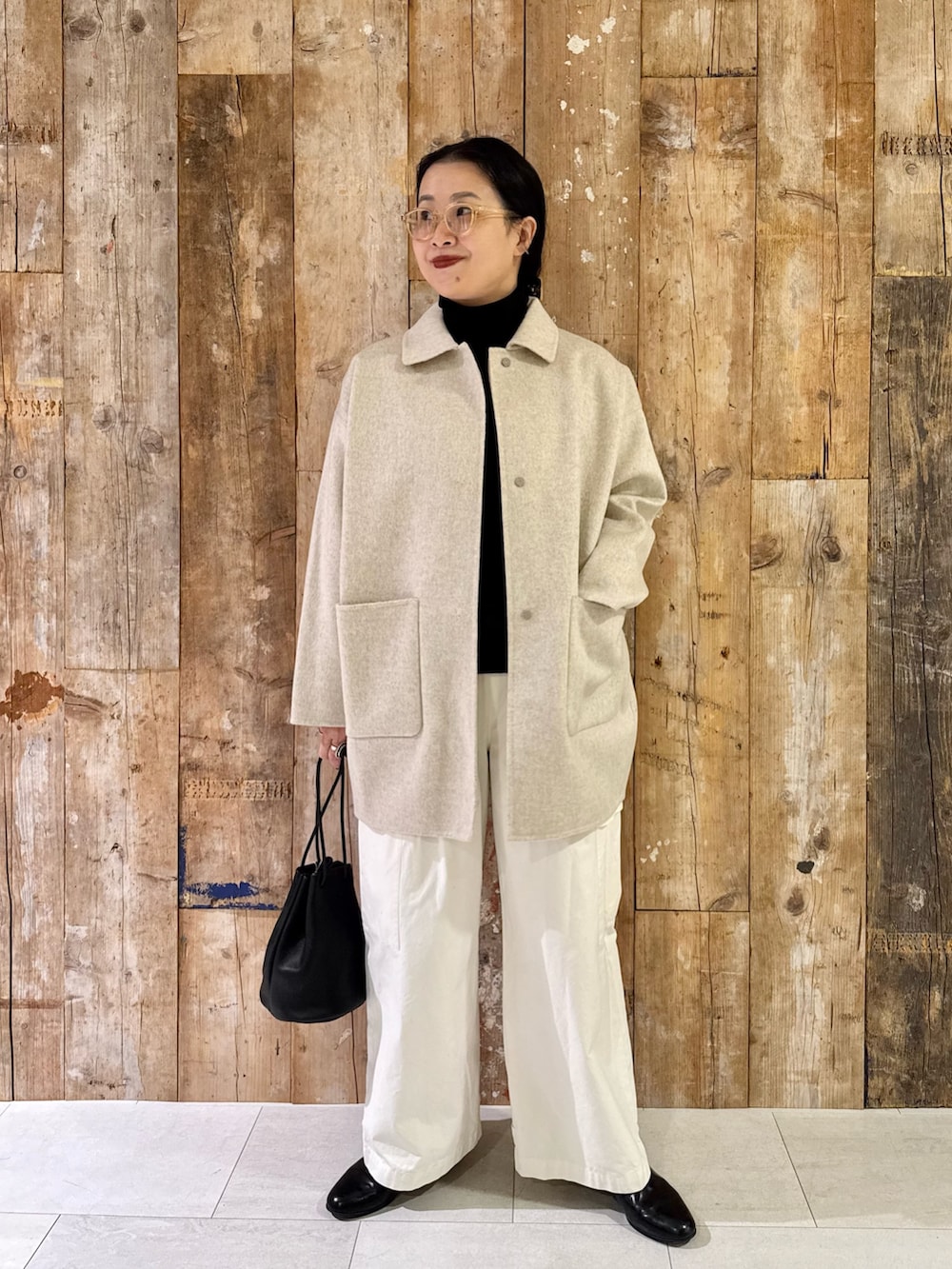 ベージュ系のその他アウター、ブラック系のニット/セーター、ホワイト系のその他パンツを着用したレディースの秋コーディネートの3枚目の写真