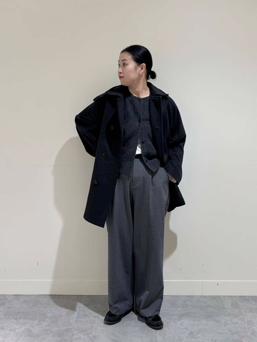 グレー系のピーコート、グレー系のその他パンツ、ホワイト系のTシャツ/カットソーを着用したレディースの冬コーディネートの4枚目の写真