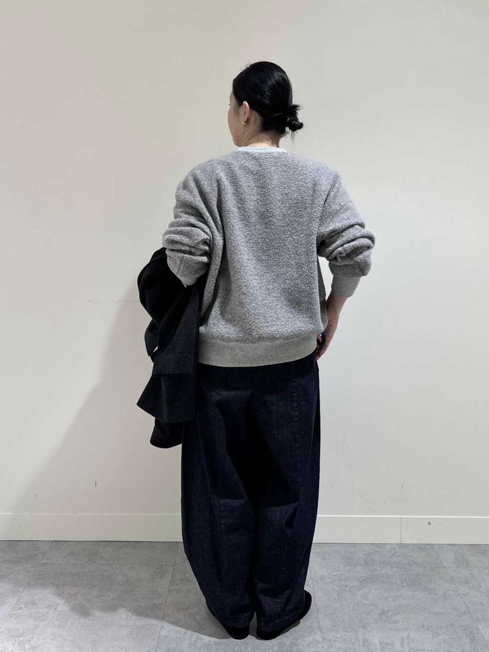 ブルー系のデニムパンツ、グレー系のピーコート、グレー系のTシャツ/カットソーを着用したレディースの冬コーディネートの4枚目の写真