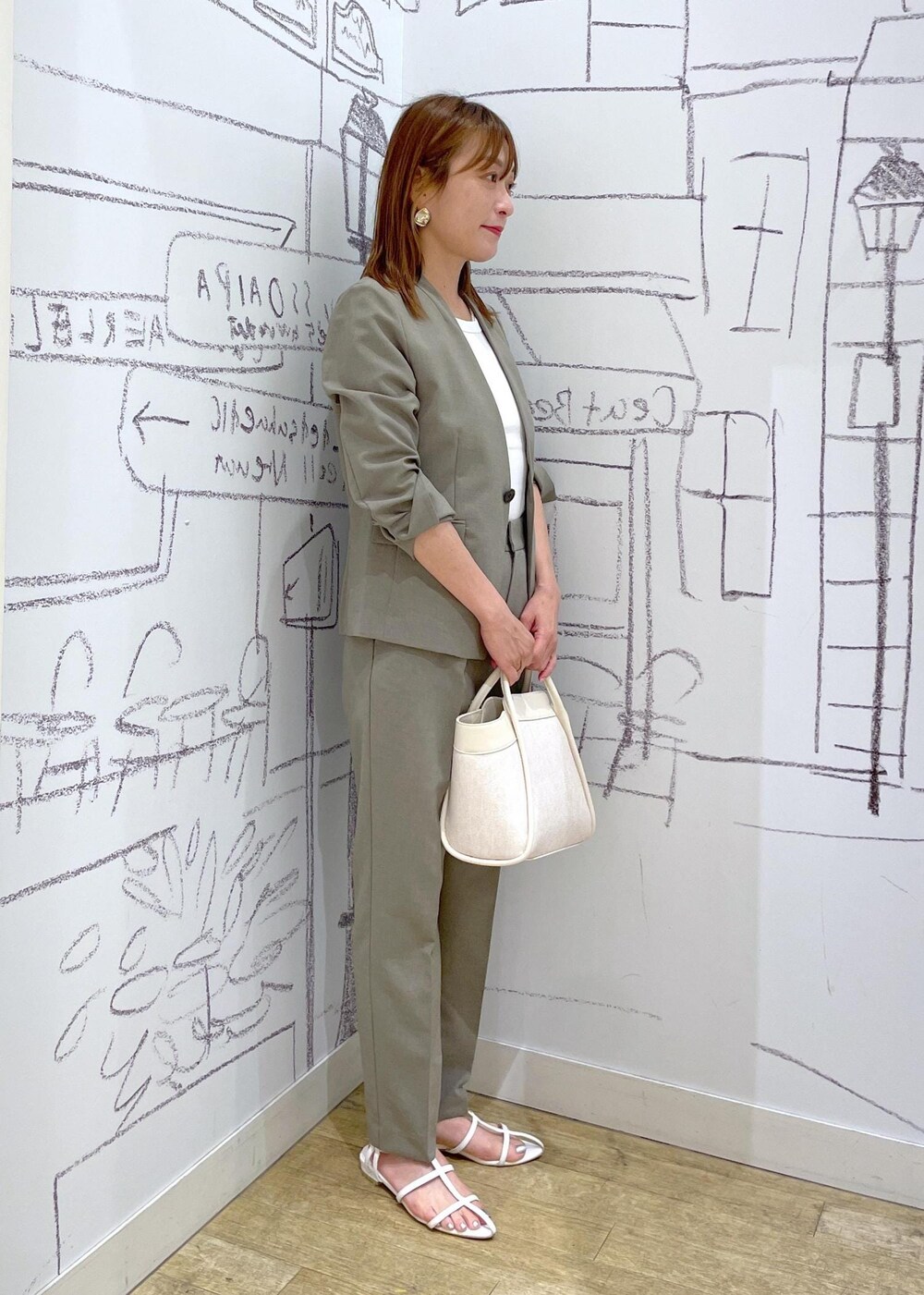 ホワイト系のタンクトップ、ホワイト系のショルダーバッグ、ブラウン系のその他パンツを着用したレディースの夏コーディネートの3枚目の写真