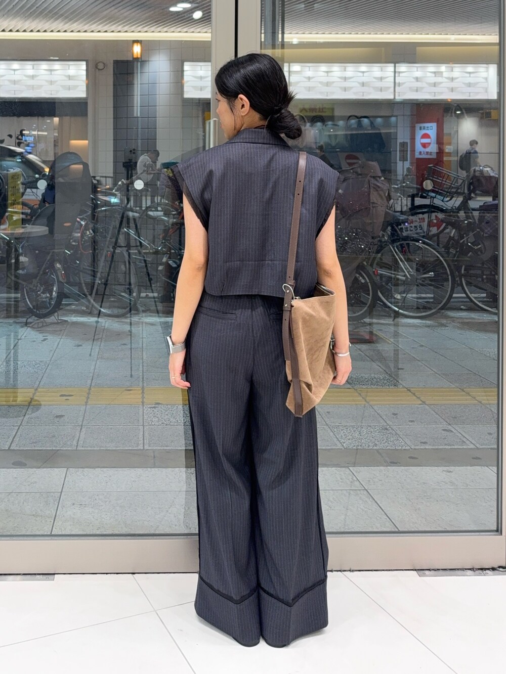 グレー系のその他パンツ、ブラック系のその他シューズ、ブラウン系のショルダーバッグを着用したレディースの夏コーディネートの3枚目の写真