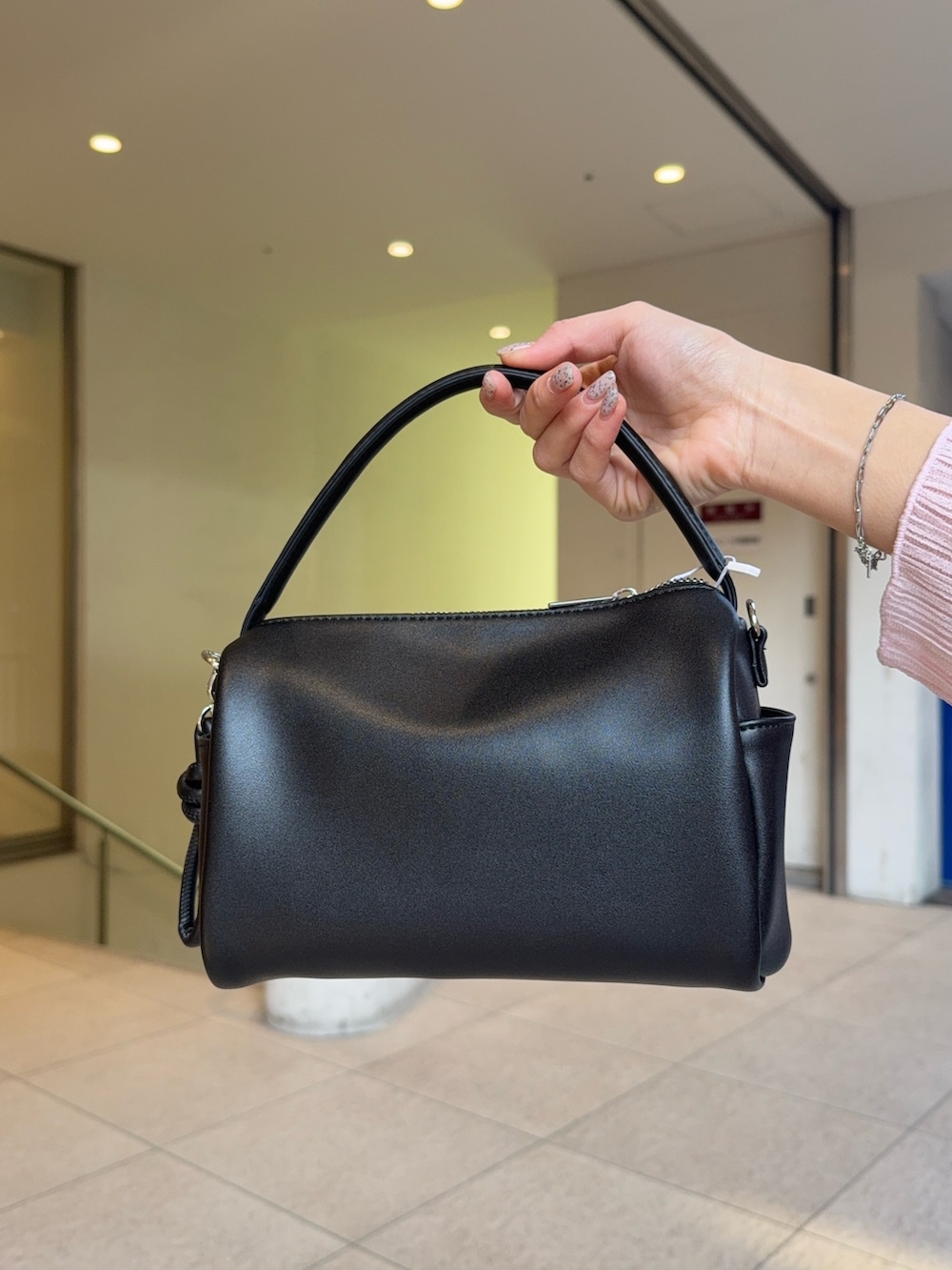 グレー系のTシャツ/カットソー、ブラック系のローファー、ベージュ系のスカートを着用したレディースの冬コーディネートの4枚目の写真