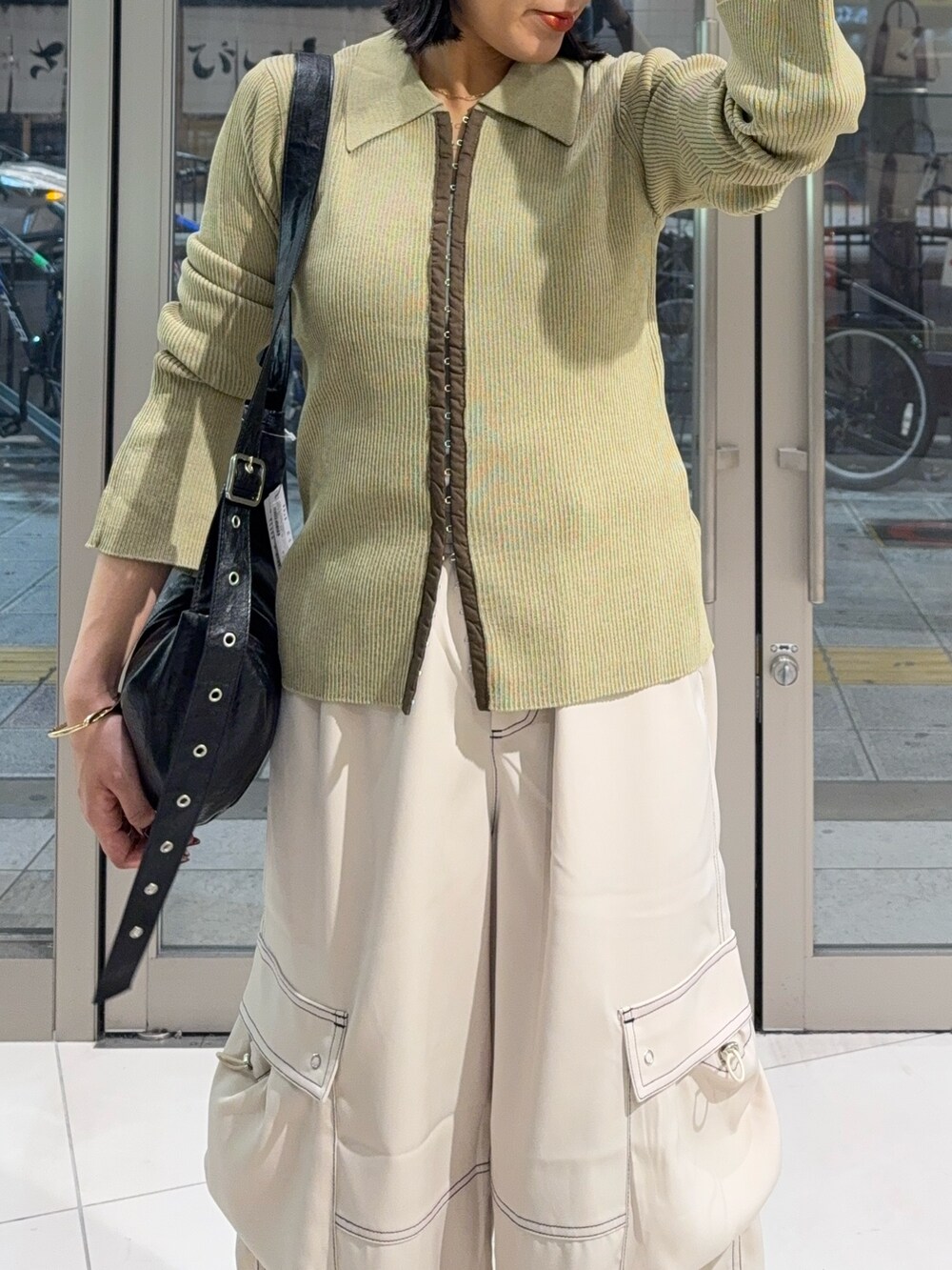 イエロー系のカーディガン/ボレロ、ホワイト系のその他パンツ、グレー系のスニーカーを着用したレディースの秋コーディネートの3枚目の写真