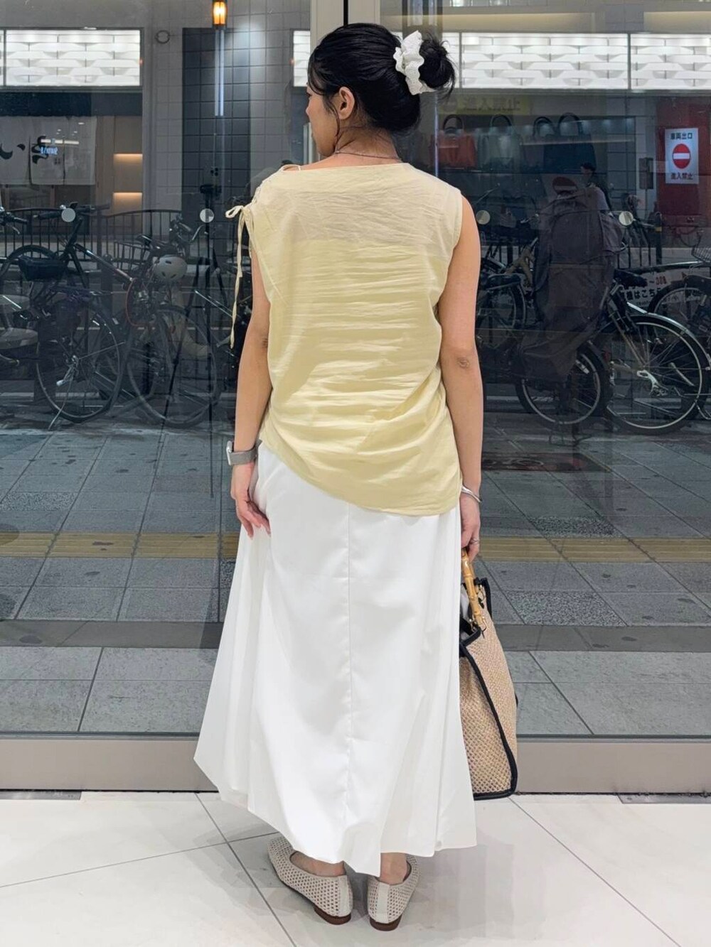 ホワイト系のスカート、ホワイト系のバレエシューズ、ベージュ系のシャツ/ブラウスを着用したレディースの夏コーディネートの2枚目の写真