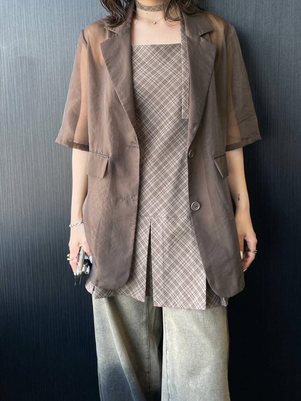 ブラック系のその他シューズ、ベージュ系のワンピース、ブラウン系のテーラードジャケットを着用したレディースの春コーディネートの5枚目の写真