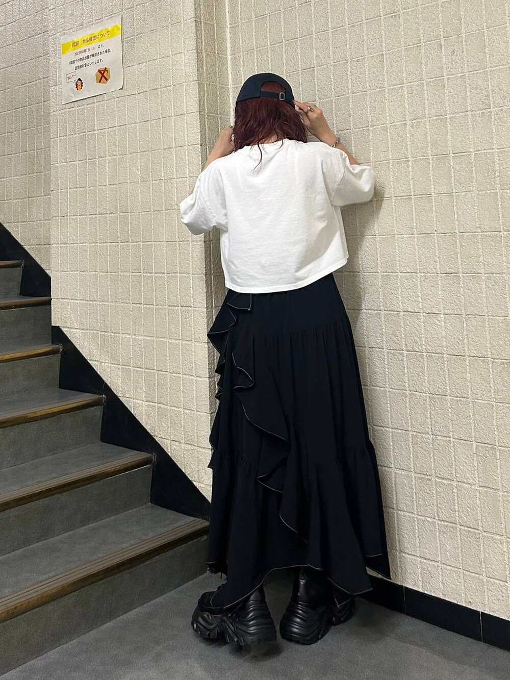ブラック系のブーツ、ブラック系のスカート、ホワイト系のTシャツ/カットソーを着用したレディースの夏コーディネートの4枚目の写真