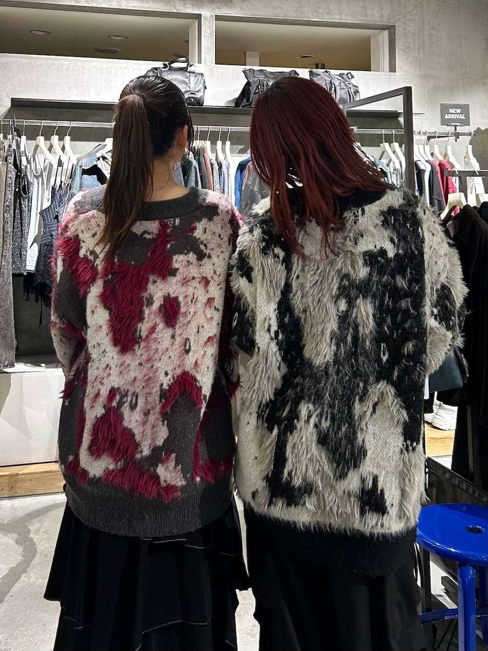ブラック系のカーゴパンツ、ブラック系のスカート、ブルー系のショルダーバッグを着用したレディースの秋コーディネートの4枚目の写真