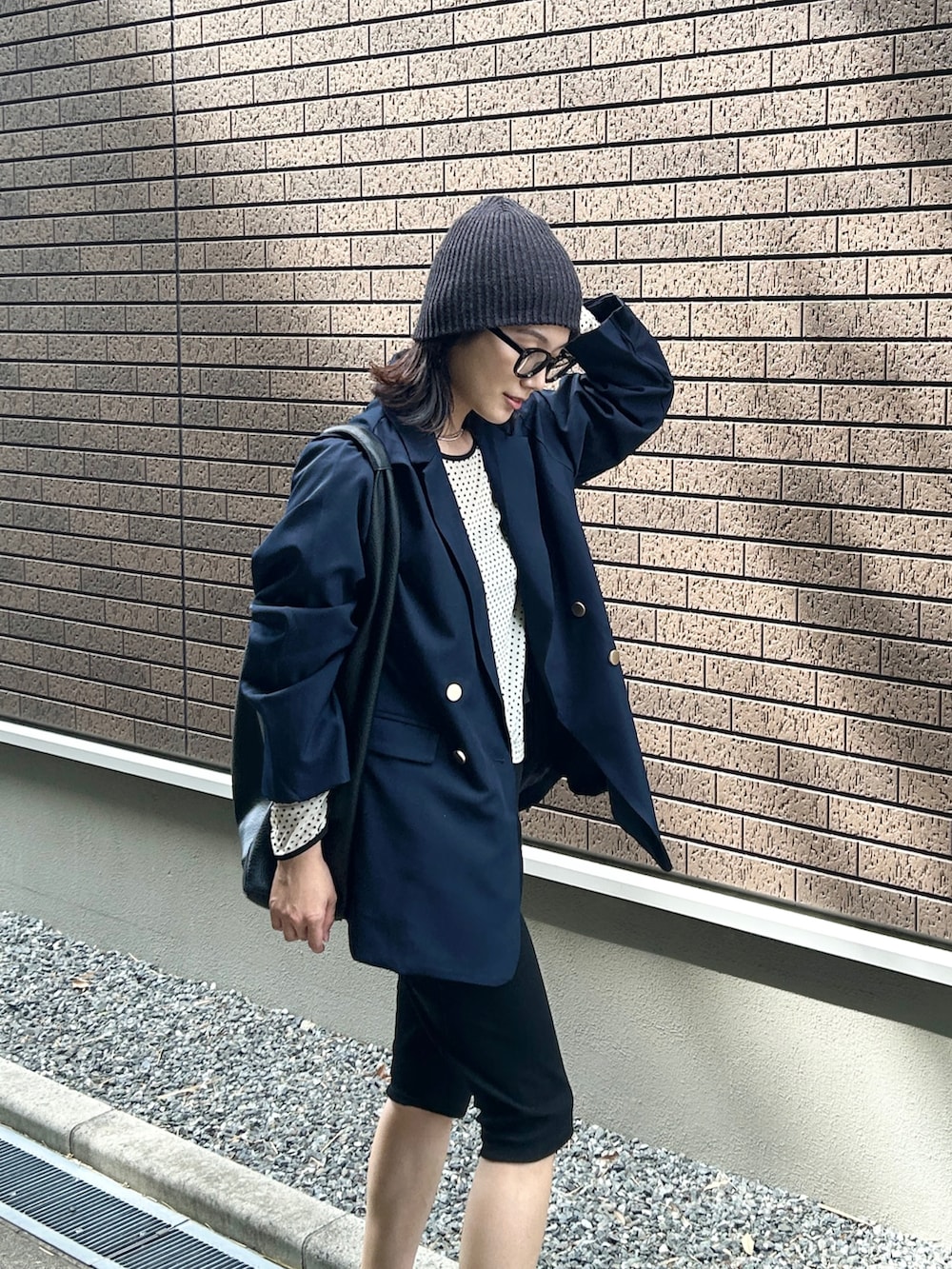 ホワイト系のTシャツ/カットソー、ブルー系のテーラードジャケット、ブラック系のその他パンツを着用したレディースの秋コーディネートの5枚目の写真