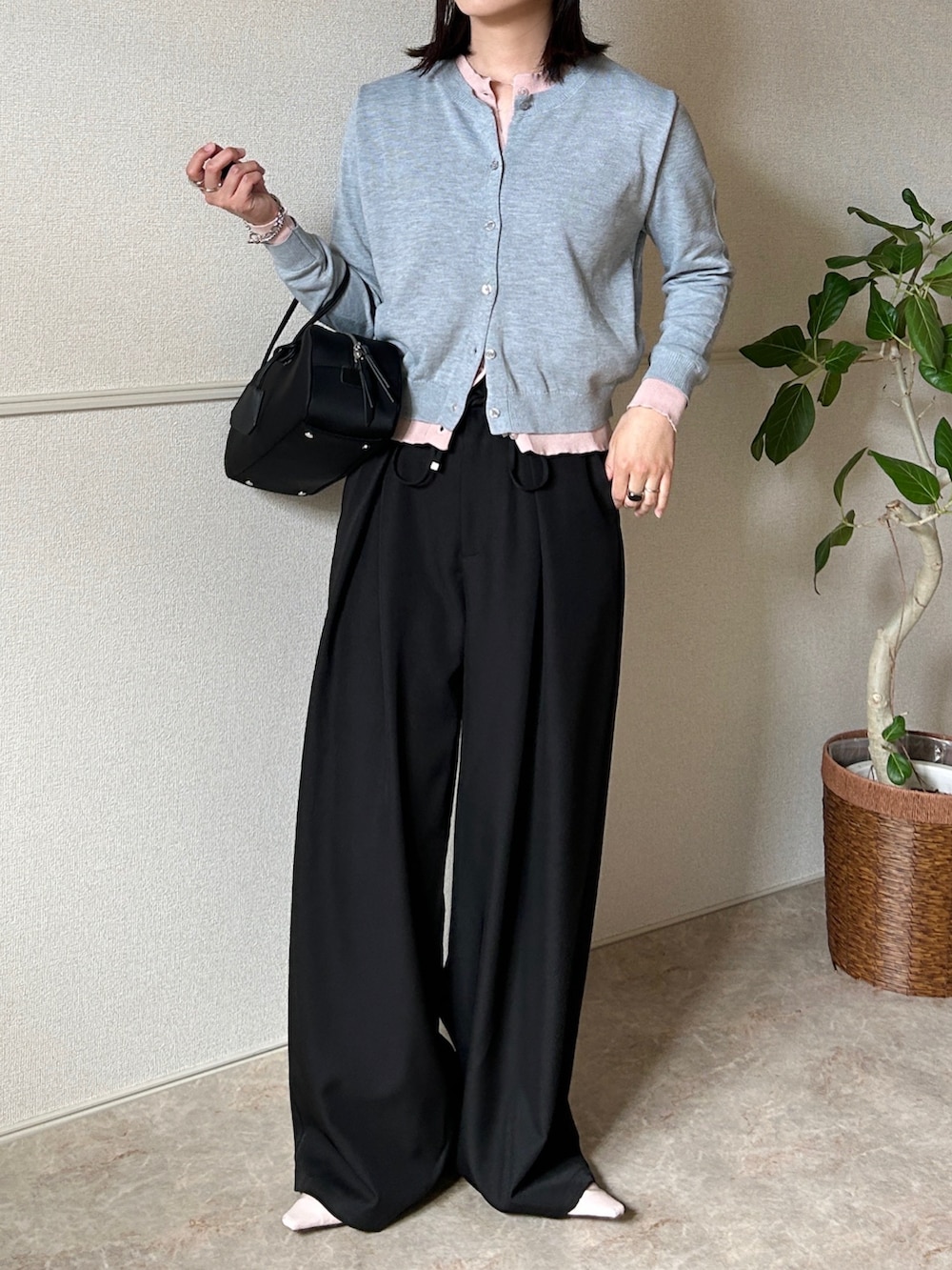 グレー系のカーディガン/ボレロ、ブラック系のボストンバッグ、ブラック系のスラックスを着用したレディースの春コーディネートの3枚目の写真