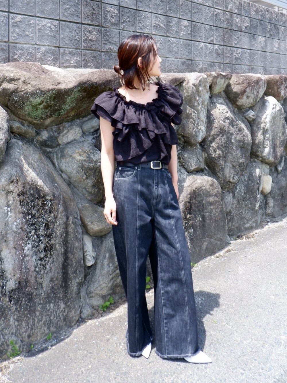 ブラック系のシャツ/ブラウス、ブルー系のデニムパンツ、ホワイト系のパンプスを着用したレディースの春コーディネートの2枚目の写真