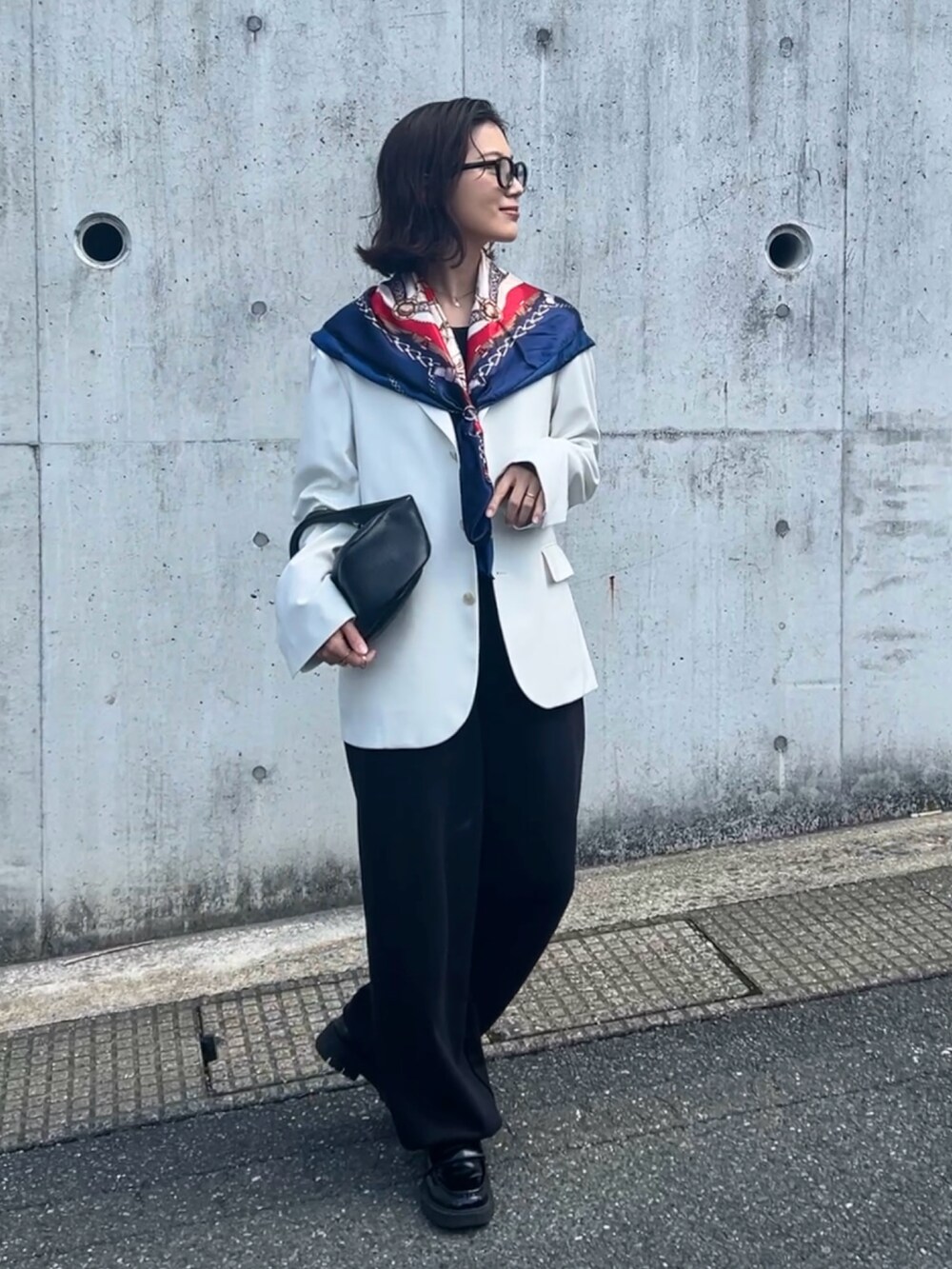 グレー系のスウェットパンツ、ブラック系のローファー、ブラック系のハンドバッグを着用したレディースの春コーディネートの2枚目の写真