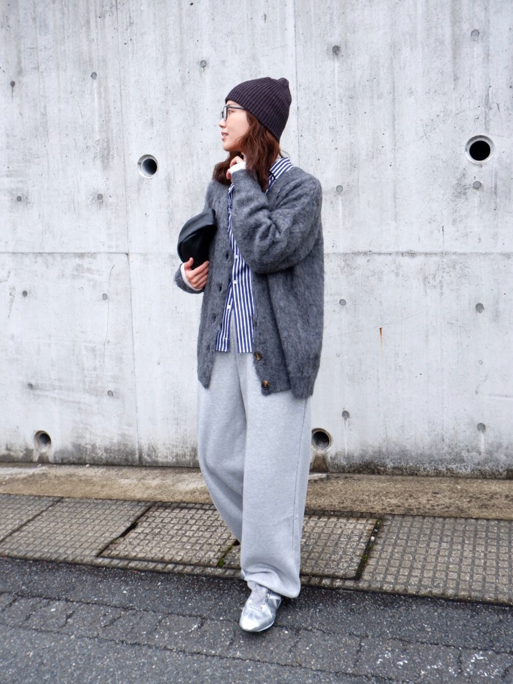 ブルー系のシャツ/ブラウス、グレー系のカーディガン/ボレロ、ブラック系のハンドバッグを着用したレディースの冬コーディネートの4枚目の写真