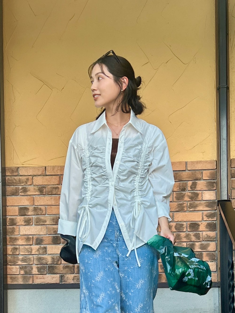 ブラック系のサンダル、ホワイト系のシャツ/ブラウス、ブルー系のデニムパンツを着用したレディースの夏コーディネートの2枚目の写真