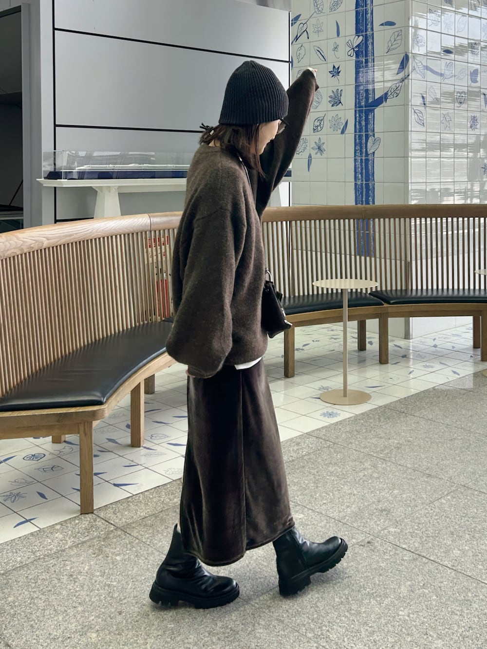 ブラック系のブーツ、ブラウン系のショルダーバッグ、ブラウン系のニット/セーターを着用したレディースの秋コーディネートの4枚目の写真