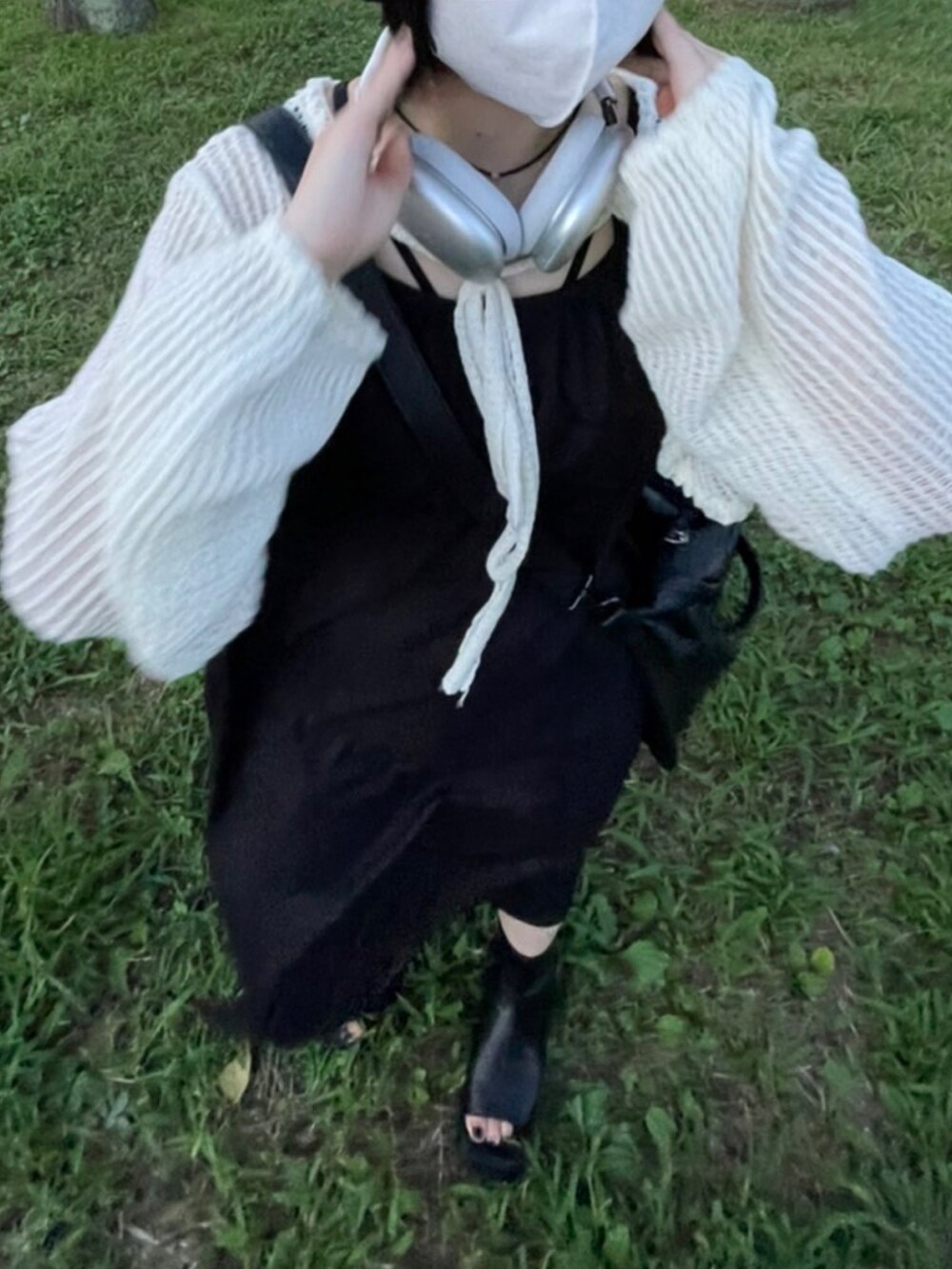 ブラック系のサンダル、ブラック系のワンピース、ホワイト系のトップスを着用したレディースの夏コーディネートの3枚目の写真