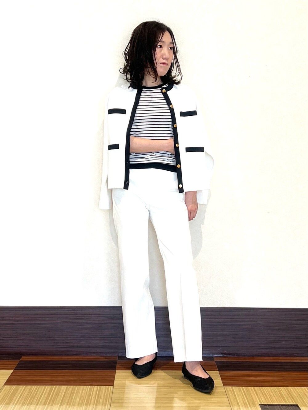 ホワイト系のカーディガン/ボレロ、ホワイト系のニット/セーター、ホワイト系のスーツパンツを着用したレディースの春コーディネートの3枚目の写真