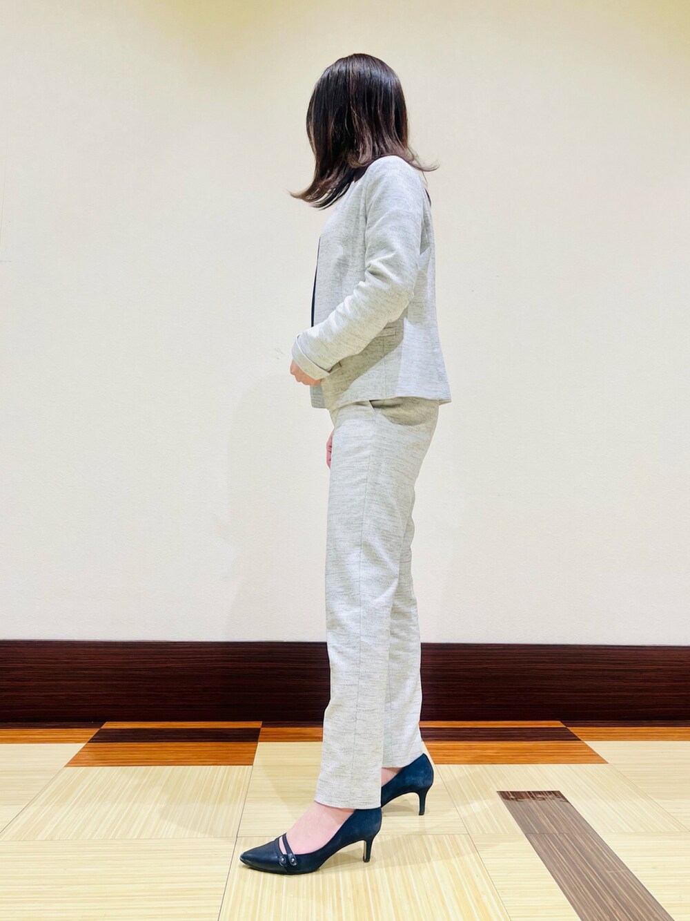 ホワイト系のスーツジャケット、ブルー系のシャツ/ブラウス、ブラック系のスーツパンツを着用したレディースの春コーディネートの4枚目の写真