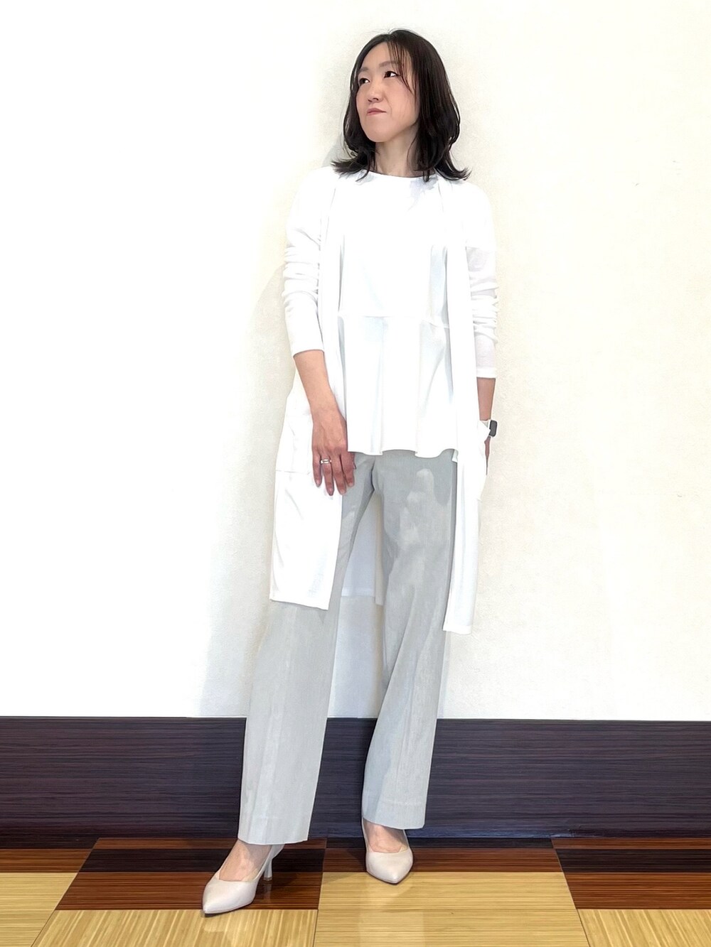 ホワイト系のシャツ/ブラウス、ホワイト系のカーディガン/ボレロ、グレー系のスーツパンツを着用したレディースの春コーディネートの2枚目の写真