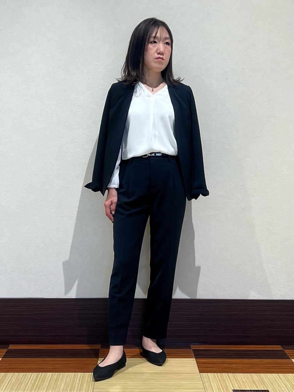 ブルー系のスーツジャケット、ホワイト系のシャツ/ブラウス、ブルー系のスーツパンツを着用したレディースの春コーディネートの4枚目の写真