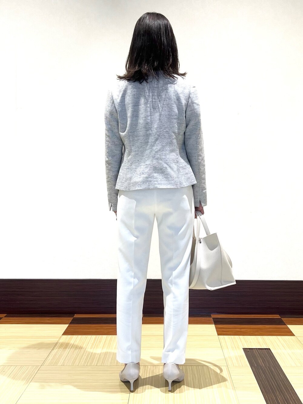 ブラック系のノーカラージャケット、ホワイト系のシャツ/ブラウス、ホワイト系のその他パンツを着用したレディースの春コーディネートの5枚目の写真