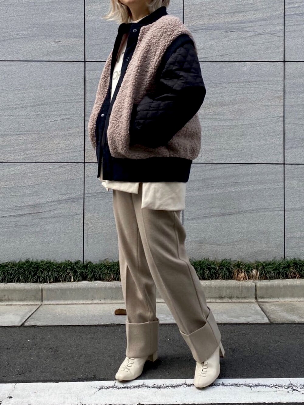 ブラウン系のブルゾン、ホワイト系のスウェット、ベージュ系のその他パンツを着用したレディースの冬コーディネートの2枚目の写真