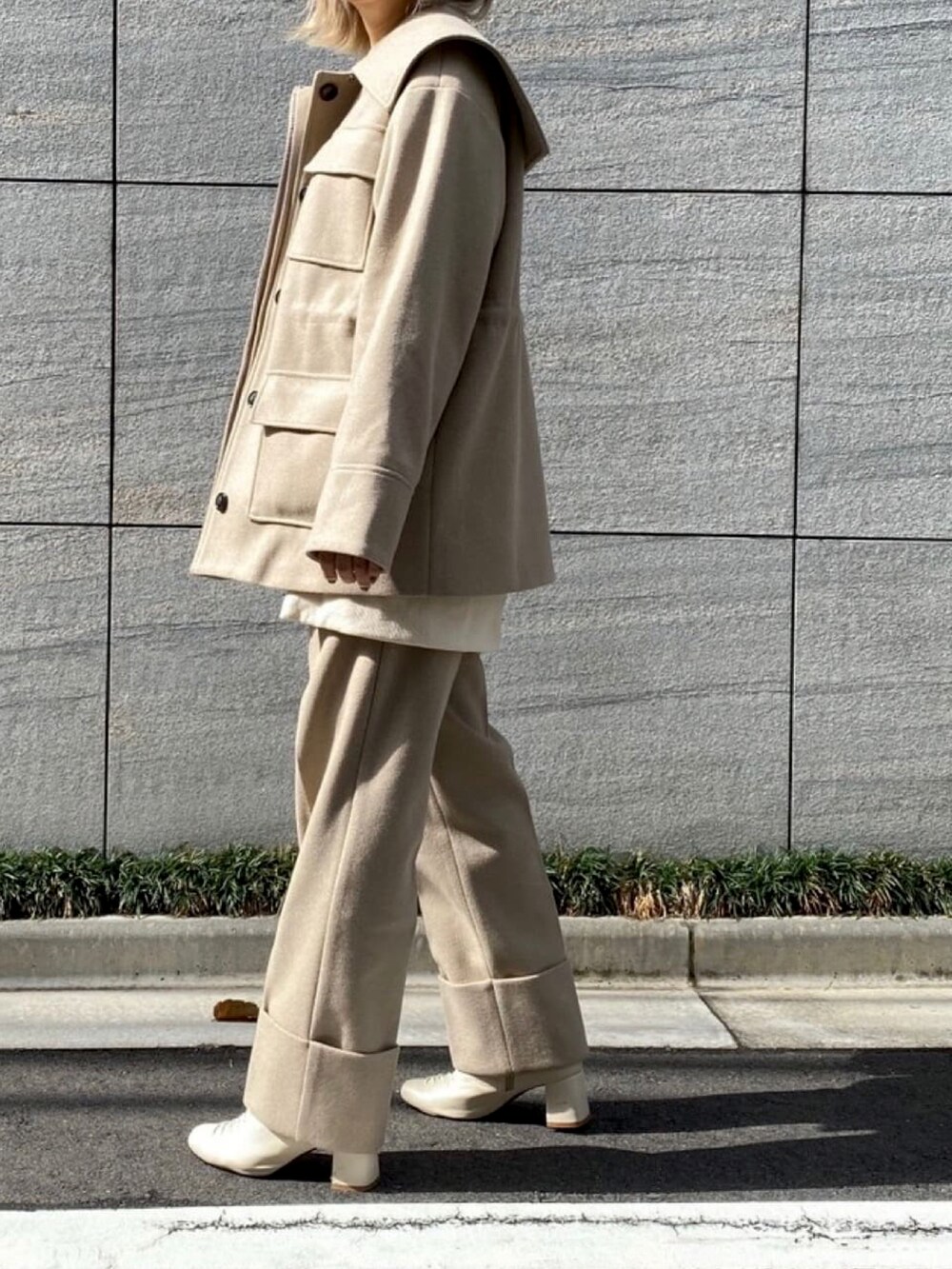 ベージュ系のカバーオール、ベージュ系のその他パンツ、ホワイト系のスウェットを着用したレディースの冬コーディネートの3枚目の写真