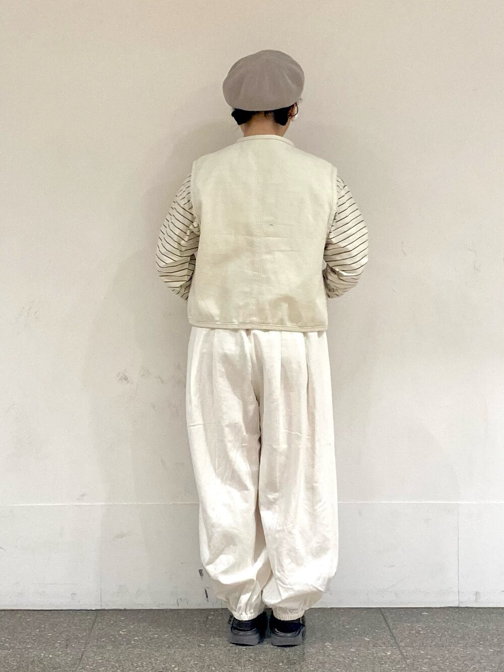 ベージュ系のTシャツ/カットソー、ホワイト系のベスト、ホワイト系のその他パンツを着用したレディースの冬コーディネートの3枚目の写真