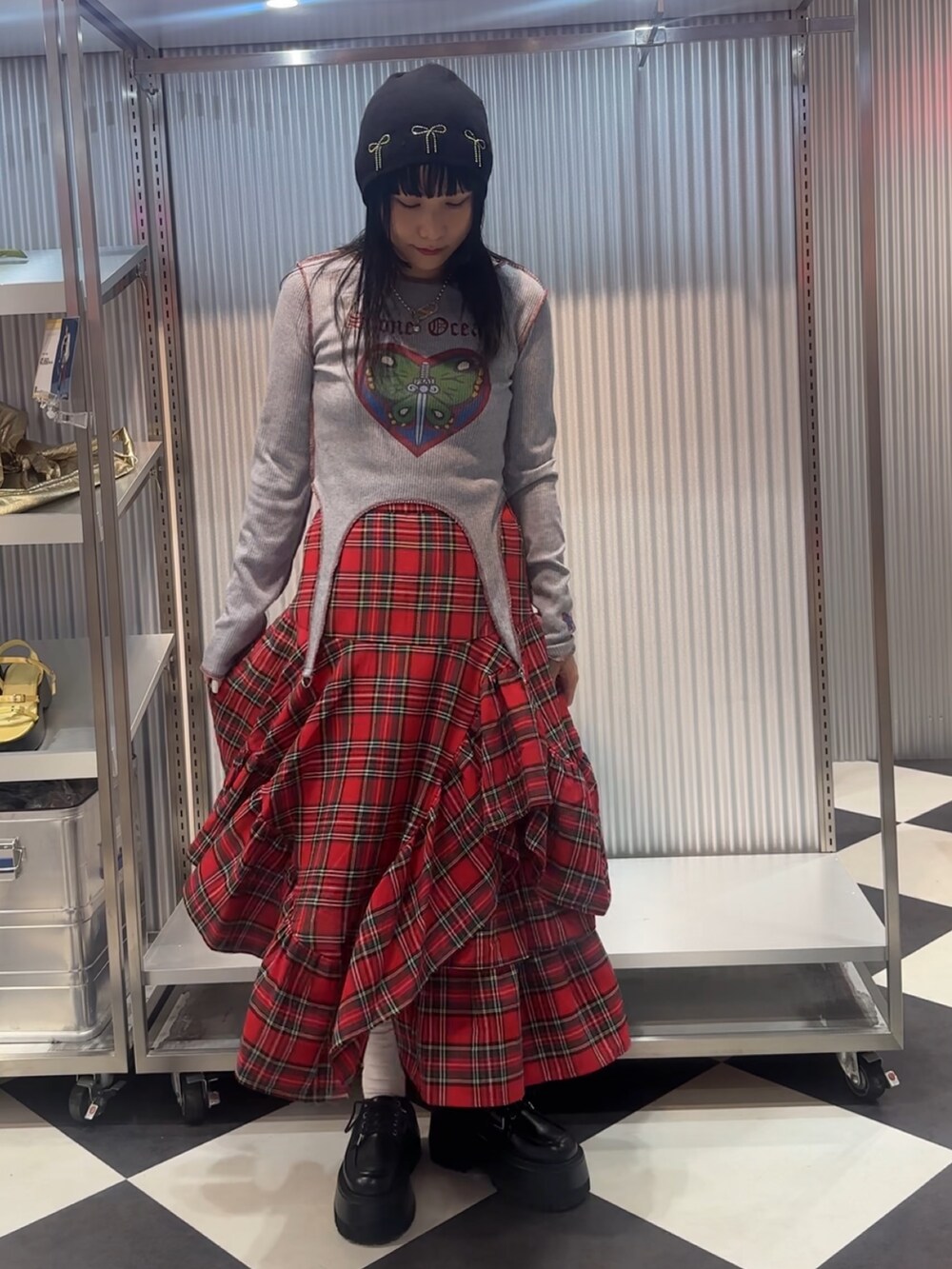 ブルー系のTシャツ/カットソー、レッド系のスカート、ブラック系のドレスシューズを着用したレディースの秋コーディネートの2枚目の写真