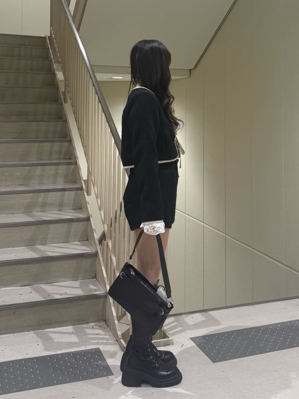 ブラック系のブーツ、ブラック系のノーカラージャケット、ブラック系のその他パンツを着用したレディースの冬コーディネートの4枚目の写真