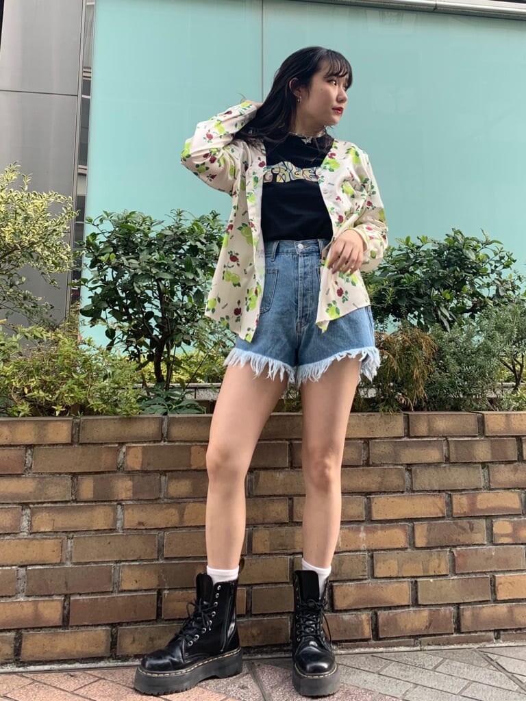 ホワイト系のシャツ/ブラウス、ブラック系のTシャツ/カットソー、ブルー系のデニムパンツを着用したレディースの春コーディネートの2枚目の写真