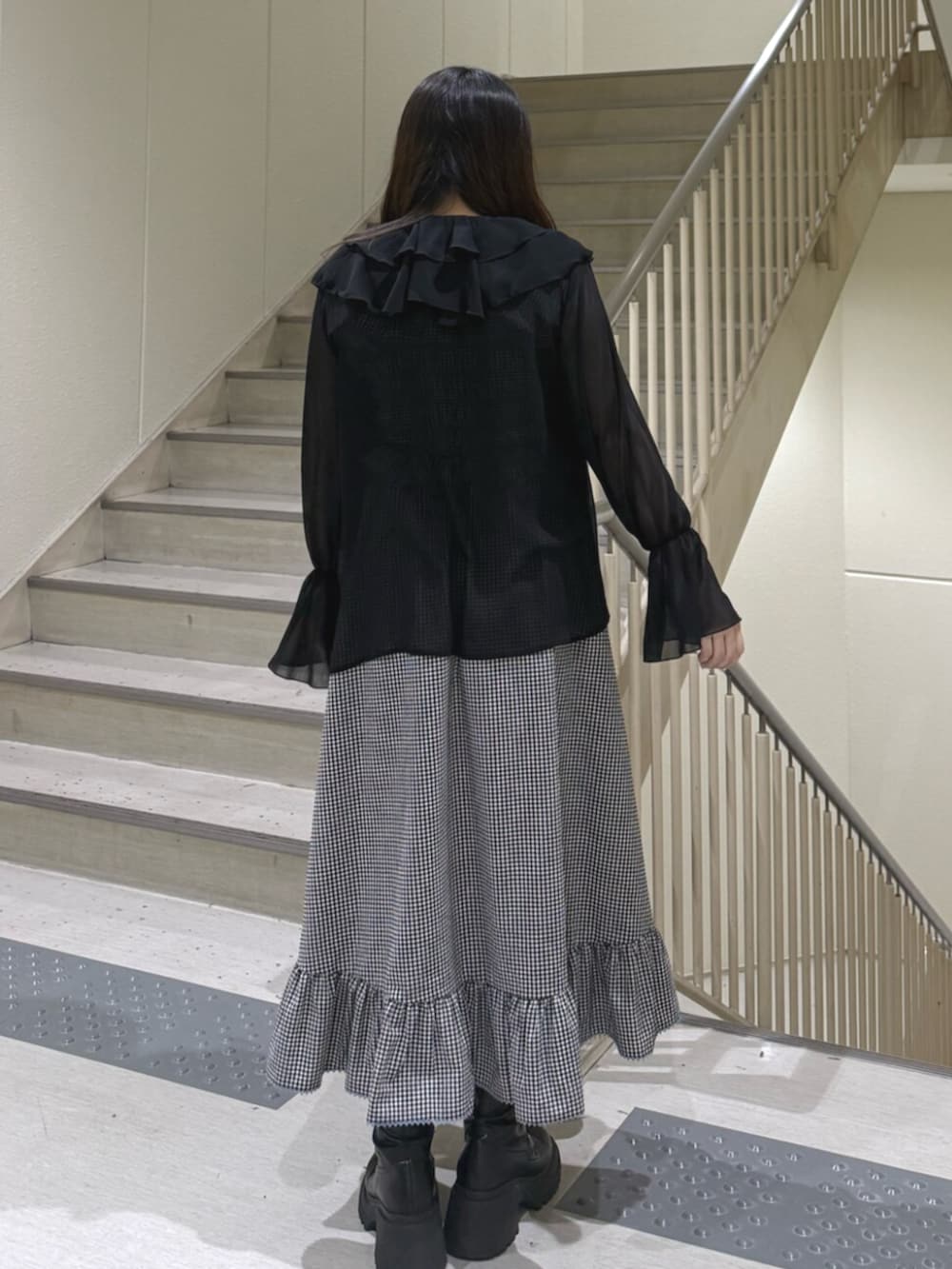 ブラック系のブーツ、ブラック系のシャツ/ブラウス、ブラック系のワンピースを着用したレディースの春コーディネートの4枚目の写真
