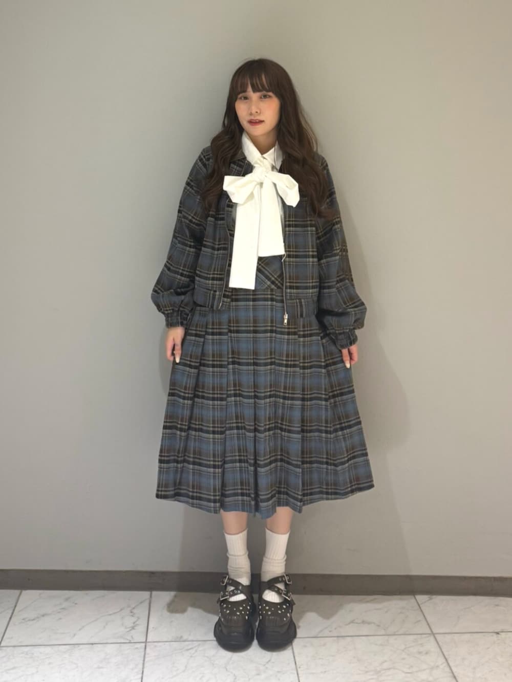 ブルー系のブルゾン、ホワイト系のシャツ/ブラウス、ブルー系のスカートを着用したレディースの夏コーディネートの4枚目の写真
