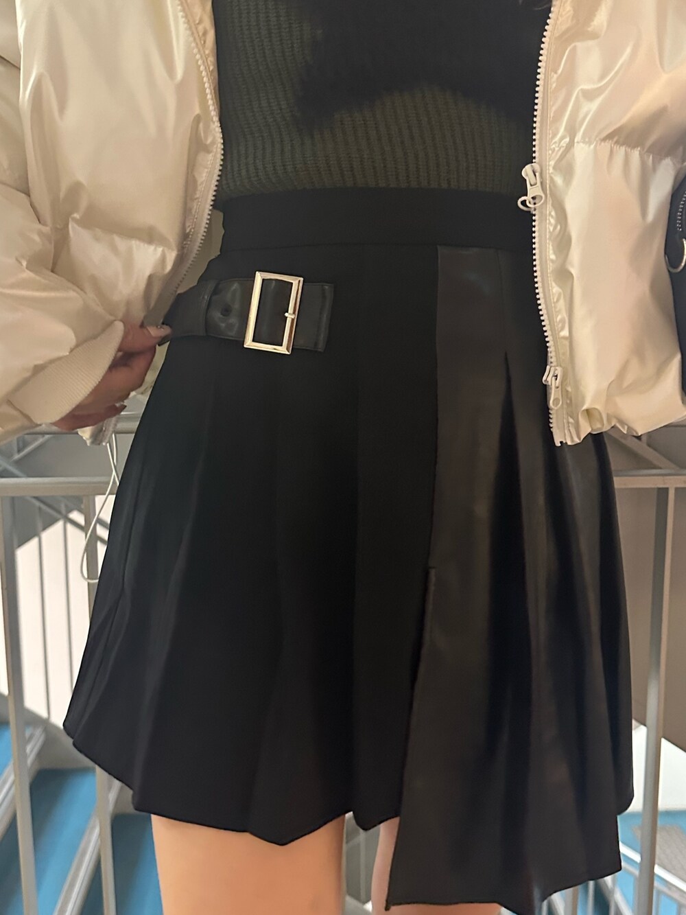 ブラック系のボストンバッグ、ホワイト系のダウンジャケット/コート、グリーン系のニット/セーターを着用したレディースの冬コーディネートの5枚目の写真