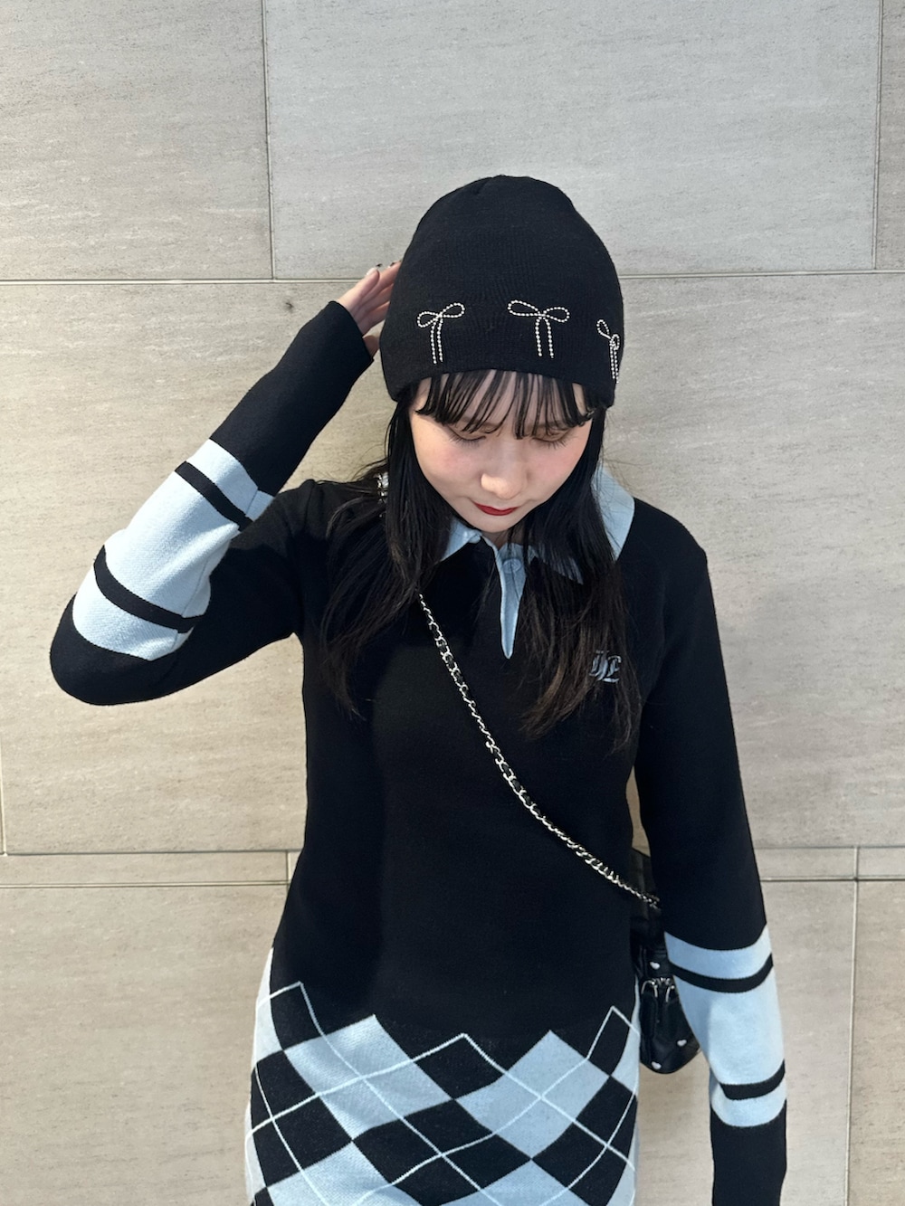 ブラック系のブーツ、ブラック系のワンピース、ブラック系のショルダーバッグを着用したレディースの秋コーディネートの5枚目の写真