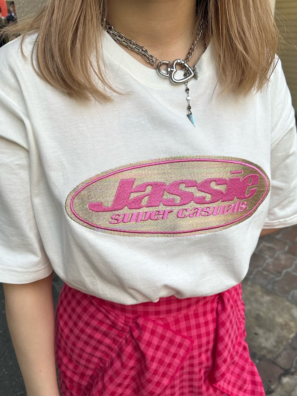 ブラック系のブーツ、ホワイト系のTシャツ/カットソー、ピンク系のスカートを着用したレディースの春コーディネートの5枚目の写真