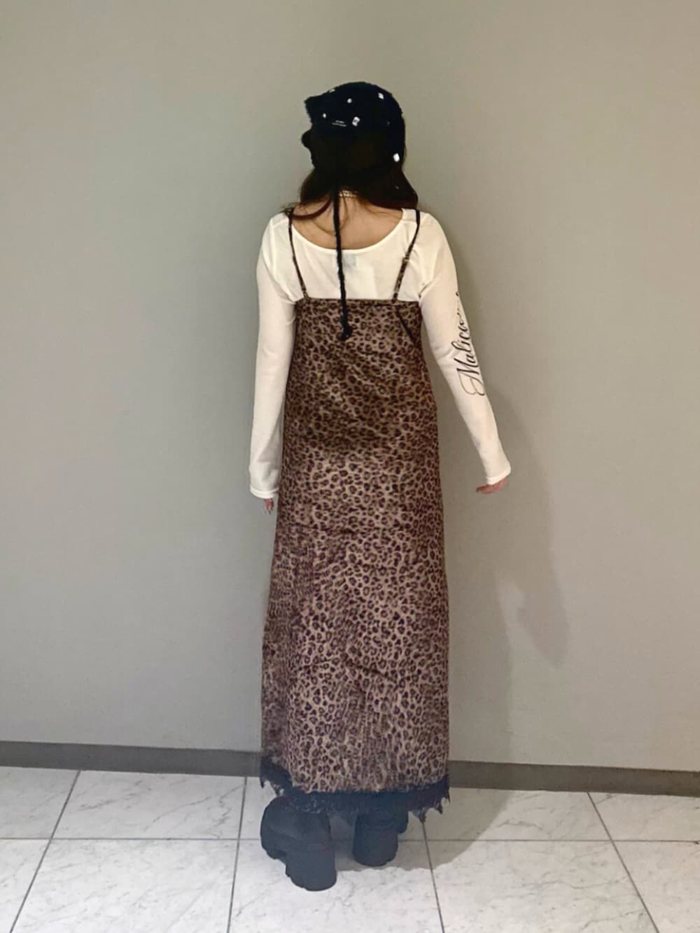 ブラック系のブーツ、ホワイト系のTシャツ/カットソー、ブラウン系のワンピースを着用したレディースの夏コーディネートの3枚目の写真