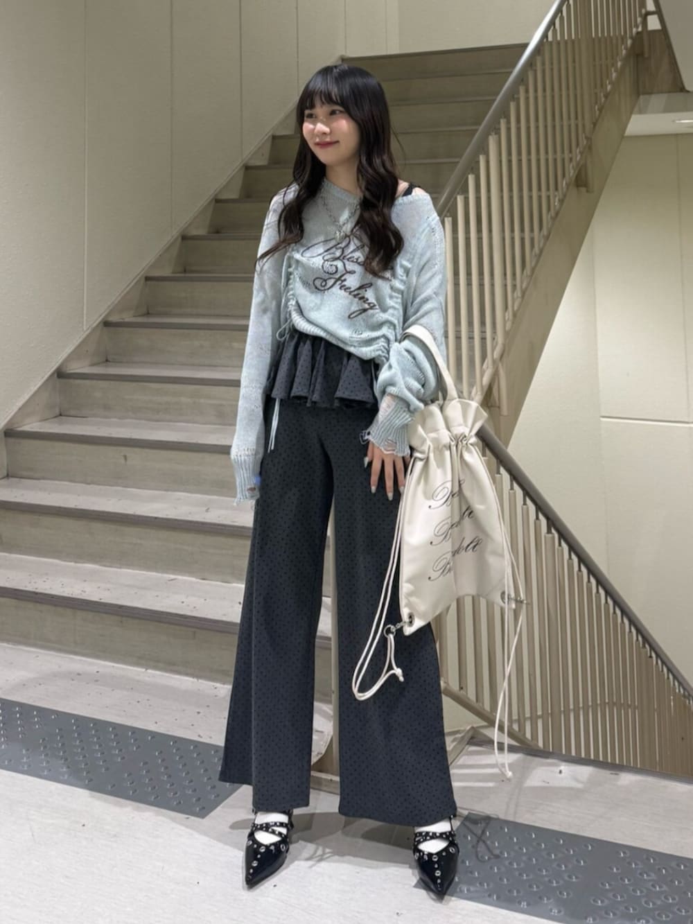 ブルー系のニット/セーター、グレー系のスウェットパンツ、ブラック系のパンプスを着用したレディースの春コーディネートの6枚目の写真