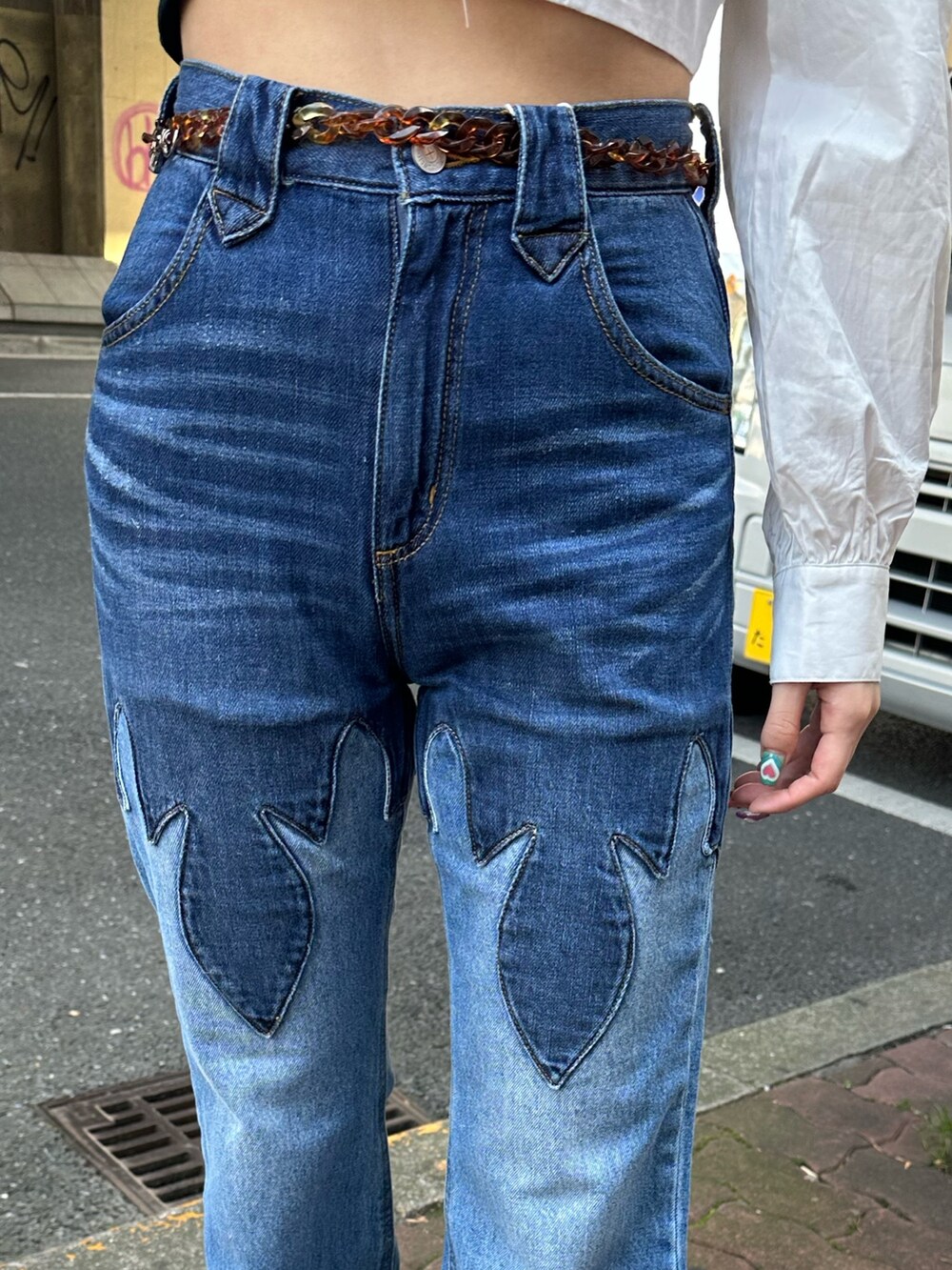 ホワイト系のシャツ/ブラウス、ブルー系のデニムパンツ、ブラック系のショルダーバッグを着用したレディースの春コーディネートの6枚目の写真