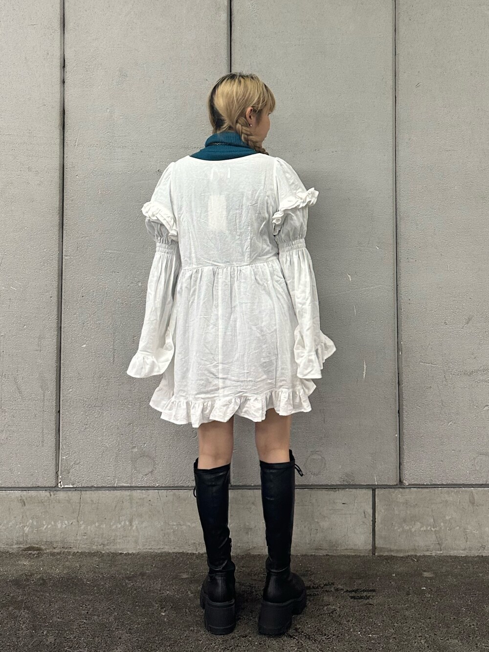 ホワイト系のワンピース、ブラック系のブーツ、ブルー系のニット/セーターを着用したレディースの秋コーディネートの3枚目の写真