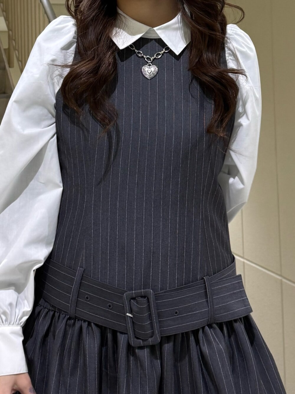 ブラック系のハンドバッグ、グレー系のシャツワンピース、ブルー系のローファーを着用したレディースの冬コーディネートの8枚目の写真