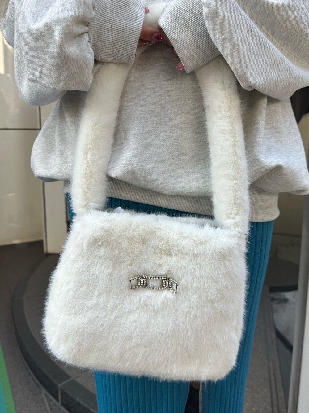 グレー系のスウェット、ブルー系のスカート、その他のブーツを着用したレディースの秋コーディネートの6枚目の写真